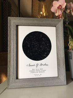 a wedding guest sign in a frame on a table next to a potted plant