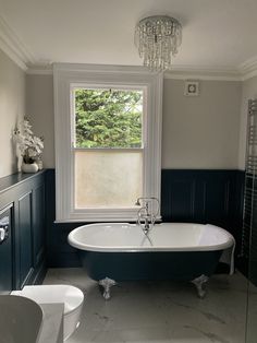 a bathroom with a claw foot tub, toilet and sink