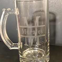 a glass mug with the letters m and l on it