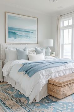 a bedroom with a large bed and blue rugs on the floor next to a window