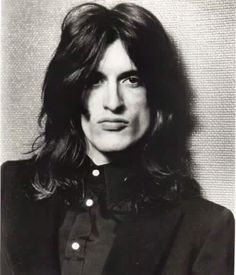 a black and white photo of a person with long hair