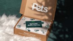 an open pet box sitting on top of a white fluffy rug