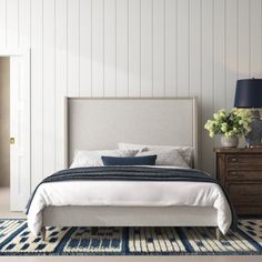 a bedroom with white walls and blue accents