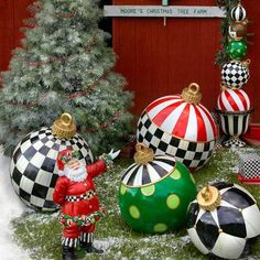 christmas ornaments are displayed in front of a red building