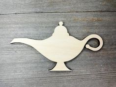 a wooden cutout of a teapot