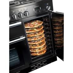 an open oven with several pizzas in it