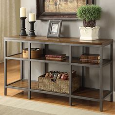 a shelf with some books on top of it next to a vase and candle holder