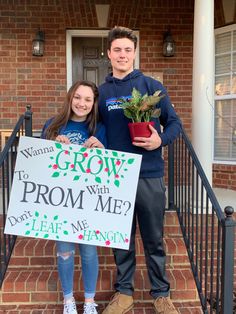 a man and woman standing on steps holding a sign that says grow to prom me