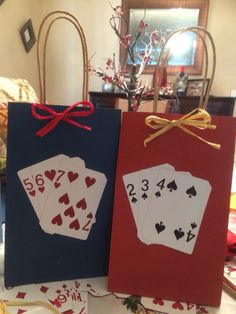 two cards are sitting on the table with red and blue tags attached to them that read, i love playing cards