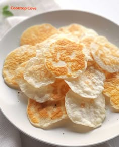 a white plate topped with chips on top of a table