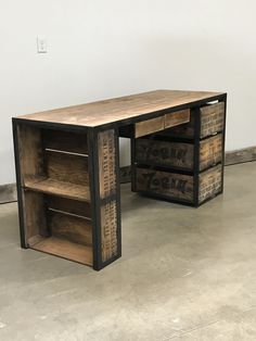 a desk made out of wooden crates on concrete floor with white wall in the background