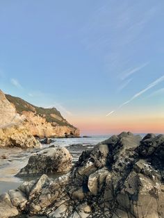 some rocks and water under a blue sky