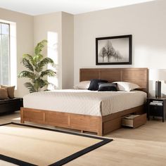 a large bed sitting in a bedroom on top of a hard wood floor next to a window