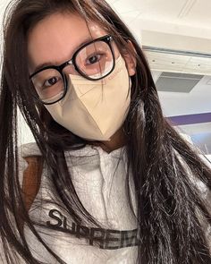 a woman with glasses and a mask covering her face