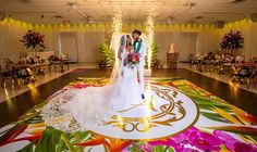 a newly married couple standing in front of a decorated dance floor at their wedding reception