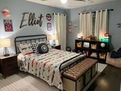 a bed room with a neatly made bed and lots of decorations on the wall above it