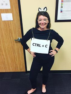 a woman dressed as a cat with glasses and a sign that says ctrl + c