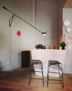 two stools sitting in front of a white counter