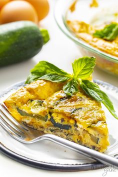 a slice of vegetable quiche on a plate with a fork