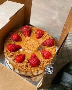 a cake in a box with strawberries on top