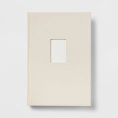 a white book with an empty square in the middle