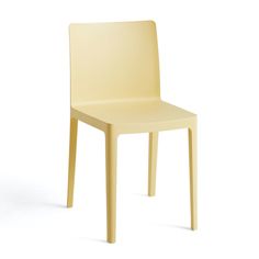 a yellow chair sitting on top of a white floor