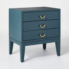 a blue nightstand with three drawers and two gold pulls on the bottom, against a white background