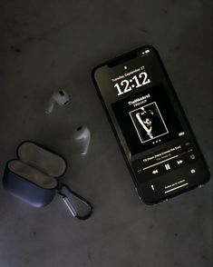 an iphone and ear buds on a table