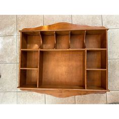 a wooden shelf with several compartments on it