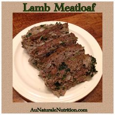 a white plate topped with meat on top of a wooden table