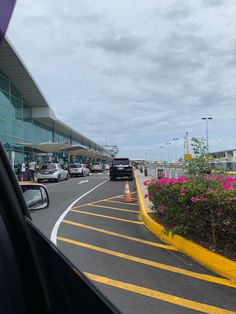 cars are parked on the side of an airport