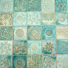 blue and green tiles with intricate designs on them, all in different shapes and sizes