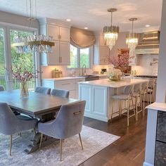 an image of a dining room table and chairs in the middle of a large kitchen