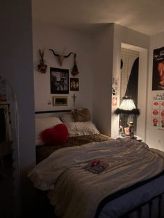 a bedroom with posters on the wall and a bed in it's center area