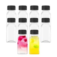 six bottles with different colored drinks in them