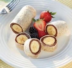 a white plate topped with bananas and strawberries