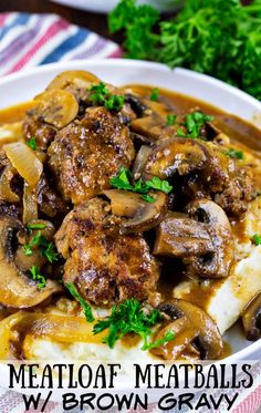 meatballs with mushrooms and gravy in a white bowl