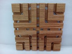 several pieces of wood are arranged in the shape of squares and rectangles on a white surface