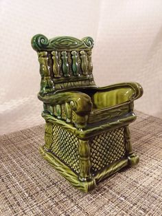 a green chair sitting on top of a table