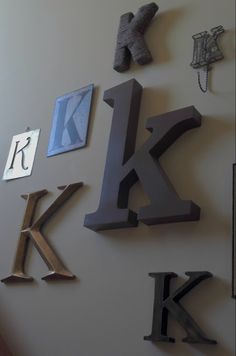 the letter k is mounted to the wall with other letters and numbers on it's side