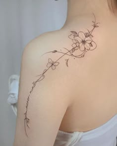 a woman's back shoulder with flowers on it and the words i love you