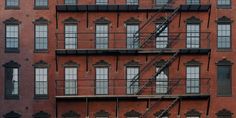 an apartment building with fire escape stairs on the side