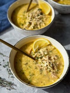 two bowls of soup with lemons and herbs