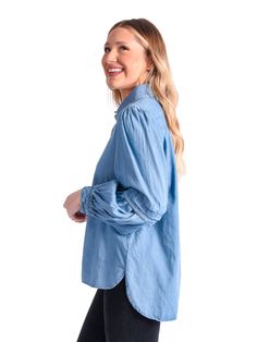 The classic Oxford shirt is our essential piece for our Core Collection. Our fun and edgy twist on a classic button-up style features a pleated balloon sleeve detail and signature gold buttons. Cotton fabric in Denim Chambray. All Emily McCarthy Clothing pieces feature a signature "Invite Joy" tag to encourage inviting joy into your life while dressing for all of life's occasions. Details: 51% Cotton 49% Spandex Slightly Tailored Fit Classic Fit with sleeve detail Fit: True to Size with slight s Trendy Shirt With Button Closure For Casual Gatherings, Trendy Shirt For Casual Gatherings, Trendy Casual Shirt For Gatherings, Trendy Cotton Blouse In Medium Wash, Trendy Cotton Denim Top With Puff Sleeves, Spring Cotton Shirt With Blouson Sleeves, Classic Fall Blouse For Casual Gatherings, Classic Cotton Tops With Pleated Sleeves, Spring Denim Top With Button Cuffs Long Sleeve