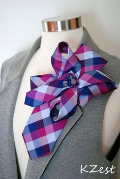 a pink and blue plaid bow tie on top of a mannequin's torso