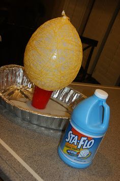 an orange sitting on top of a pan next to a bottle of san flo