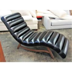 a black leather chaise lounge chair in a living room