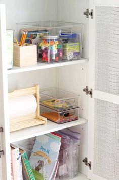 an organized pantry with clear bins and plastic containers