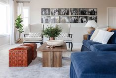 a living room filled with furniture and pictures on the wall