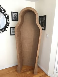 a large stone sculpture sitting on top of a hard wood floor next to a mirror